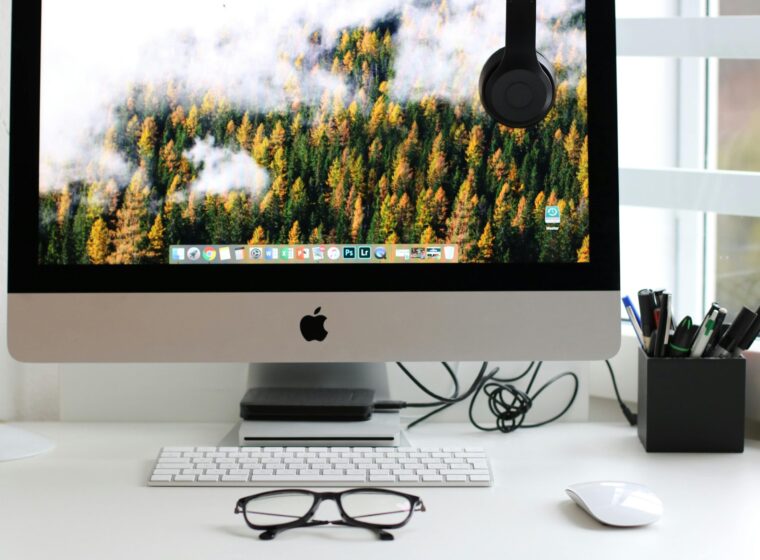 Free Stylish home office workspace featuring a computer setup with accessories. Stock Photo
