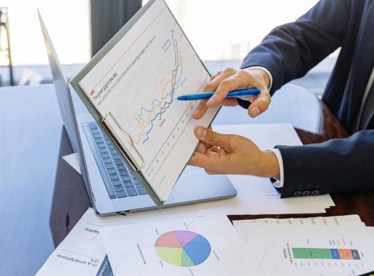 Free Business professionals discussing financial graphs and charts in an office setting. Stock Photo