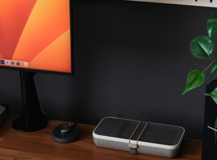 a desk with a laptop, keyboard, mouse and a monitor